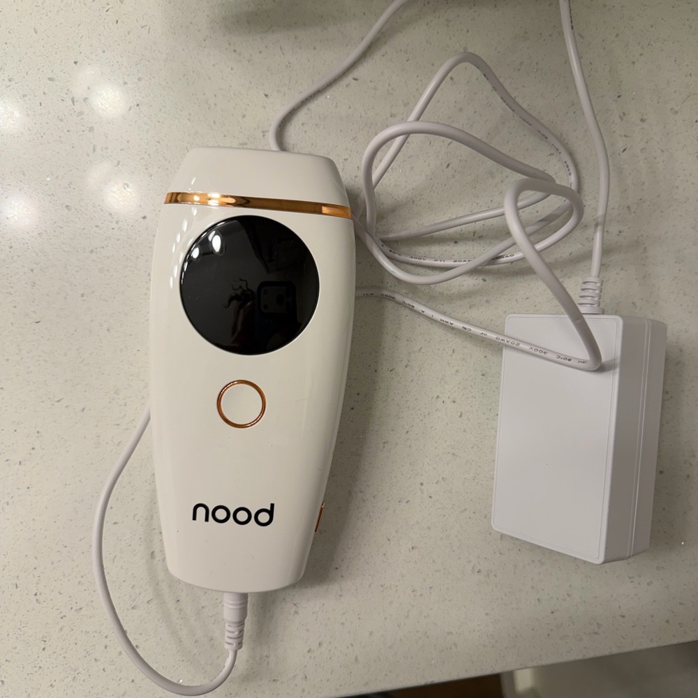 nood White and Rose Gold Handheld Electronic Device with Charger